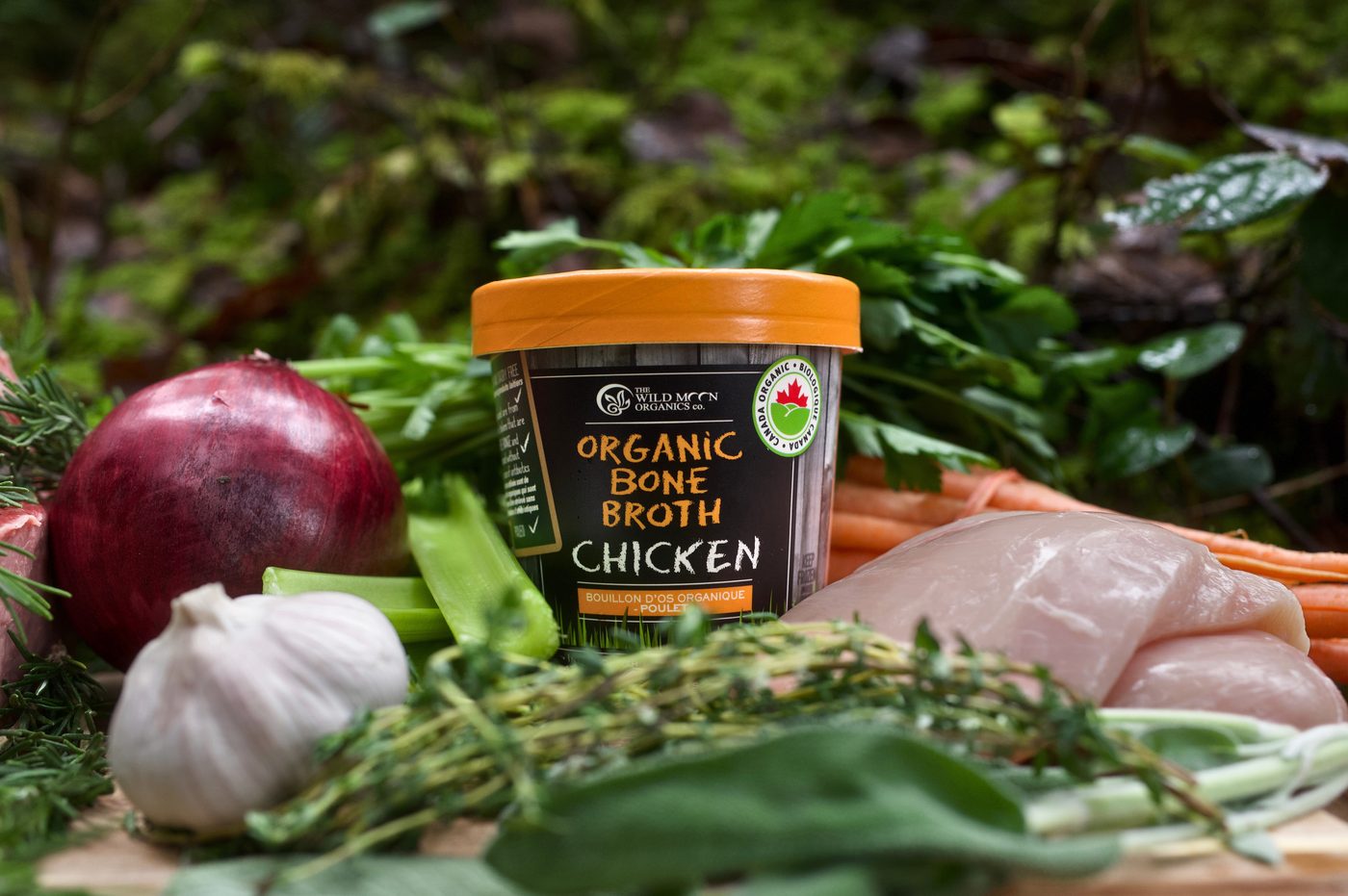 Organic chicken bone broth with raw chicken, garlic, onion, and herbs