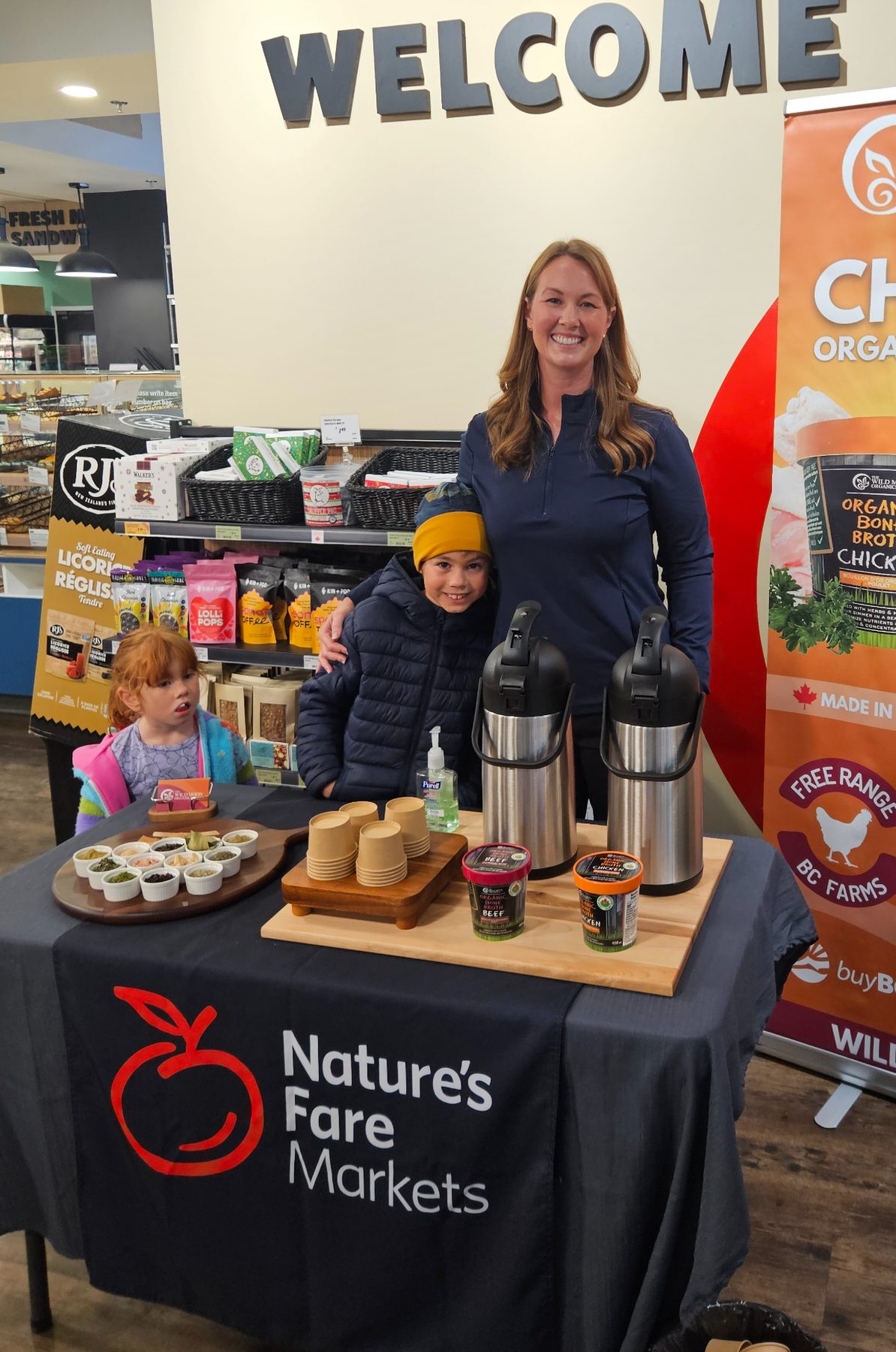 Erikka and the kids sampling Wild Moon broth at a Nature's Fare Markets demo